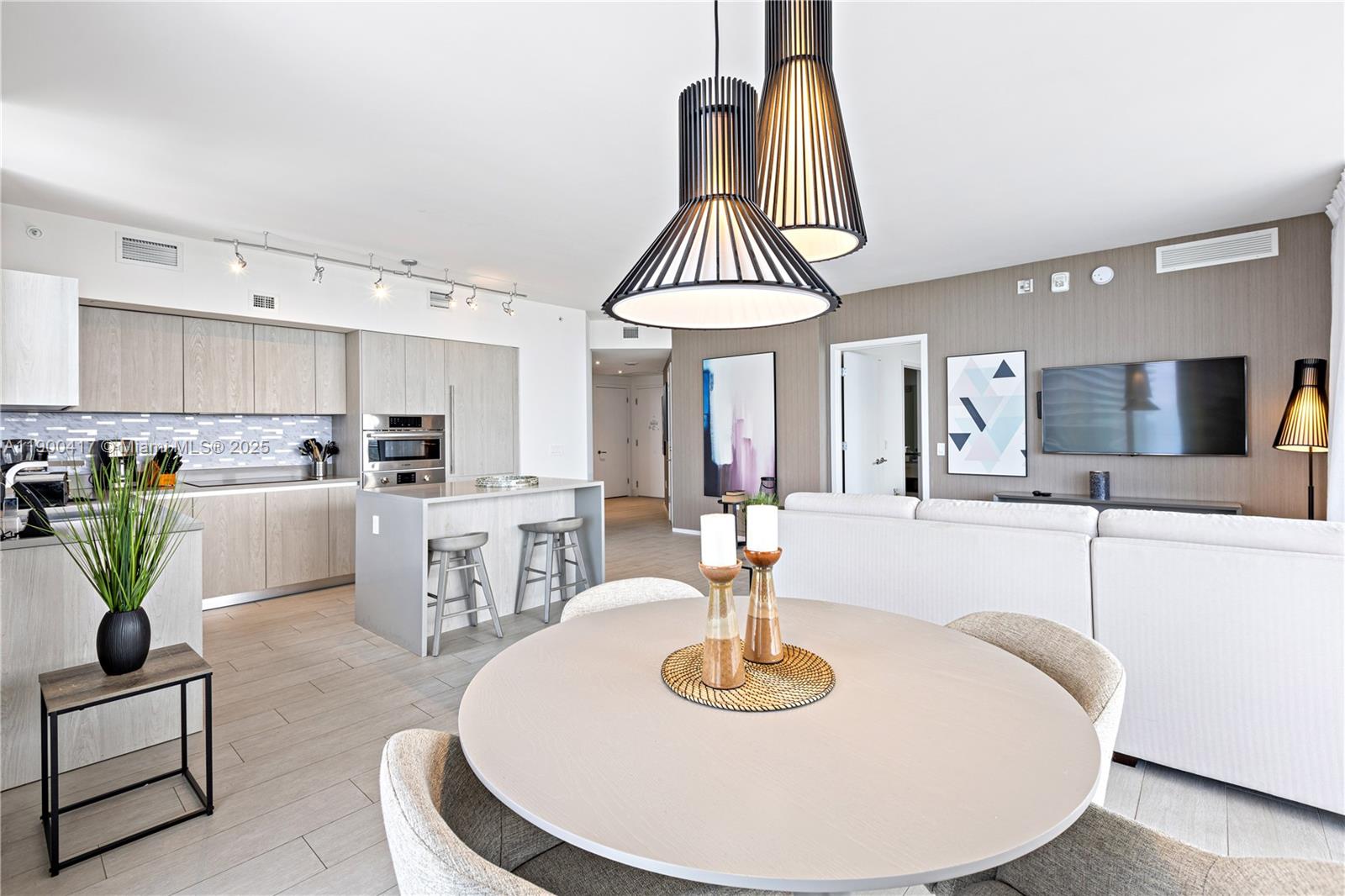 4010 South Ocean Drive, Unit R1701 Hollywood, FL 33019 - Photo 7 of 48 a living room with kitchen island furniture and a chandelier