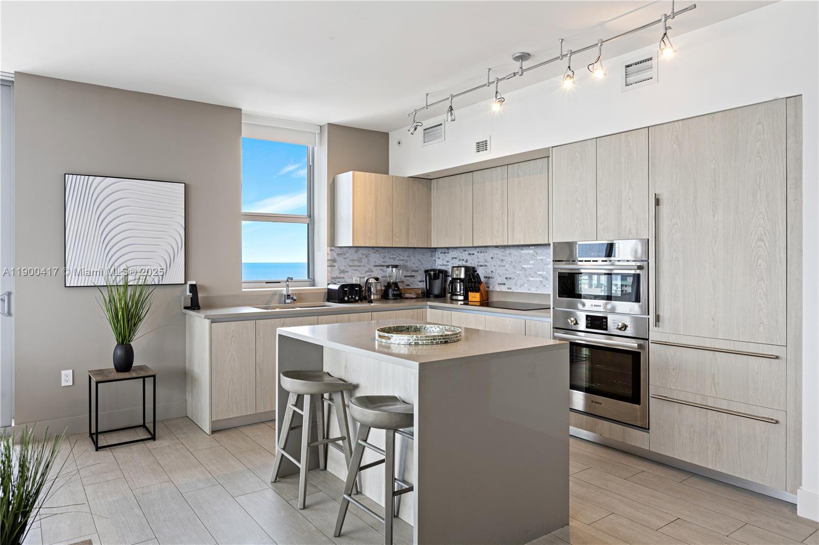 4010 South Ocean Drive, Unit R1701 Hollywood, FL 33019 - Photo 8 of 48 a kitchen with white cabinets and stainless steel appliances