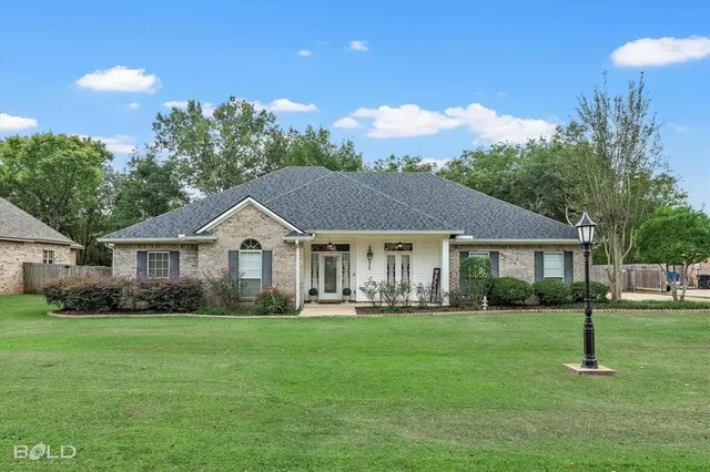 a front view of house with yard and green space