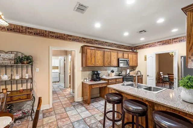 a kitchen with sink refrigerator and cabinets