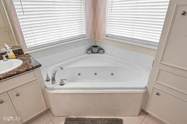 a bathroom with bathtub and window
