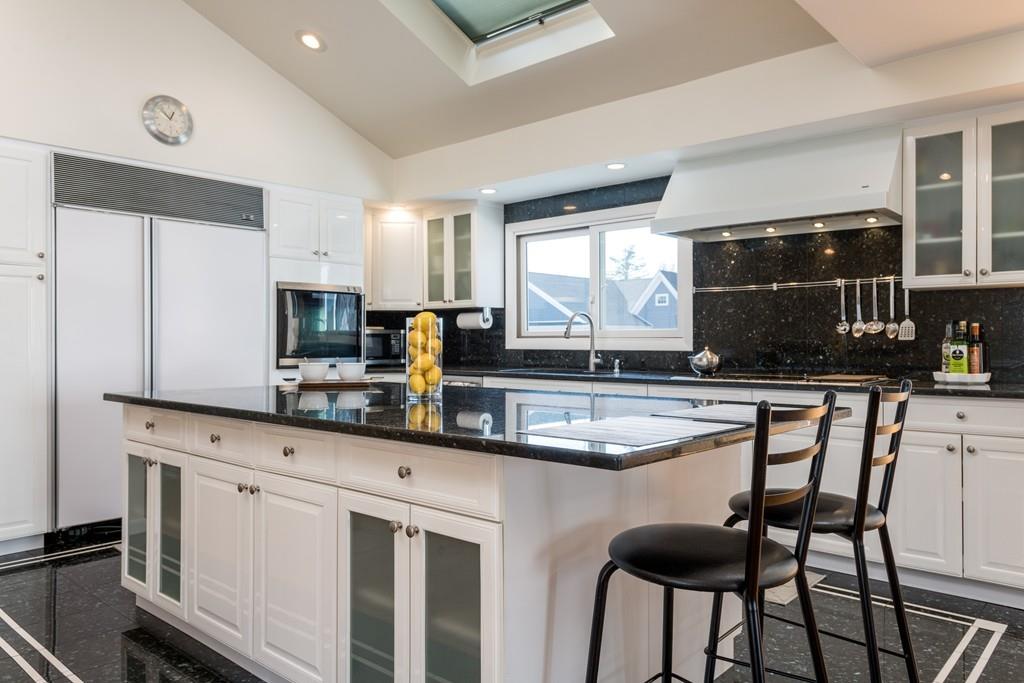 60 Arlo Road Newton, MA 02464 - Photo 3 of 28 a kitchen with stainless steel appliances granite countertop a stove a sink and a microwave
