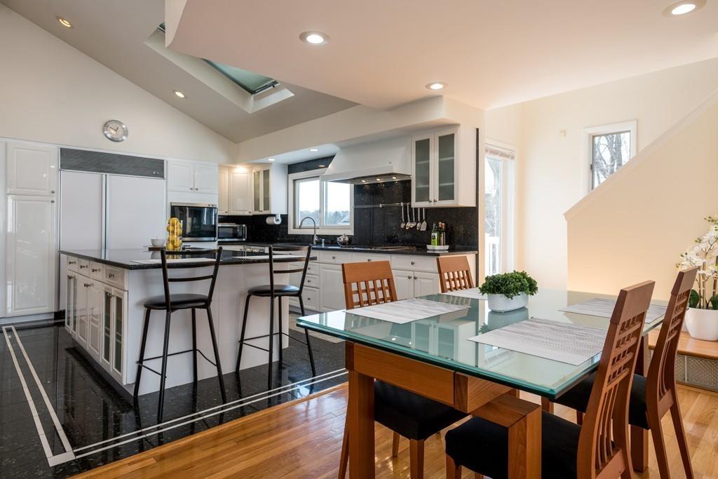 60 Arlo Road Newton, MA 02464 - Photo 4 of 28 a kitchen with stainless steel appliances granite countertop a stove a refrigerator a kitchen island a table and chairs