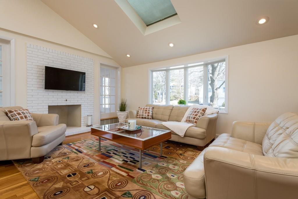 60 Arlo Road Newton, MA 02464 - Photo 5 of 28 a living room with furniture a fireplace and a flat screen tv