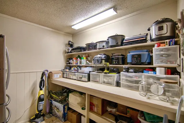 a bathroom with a granite countertop sink a toilet and a mirror