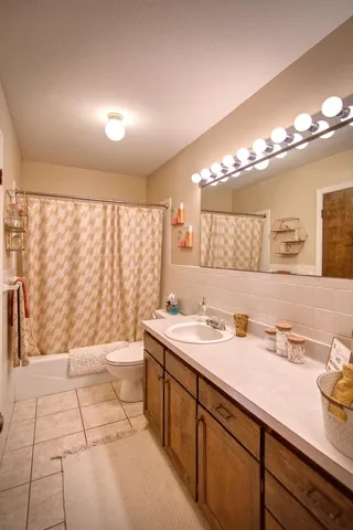 a kitchen with a refrigerator a stove a sink dishwasher with a dining table and chairs with wooden floor