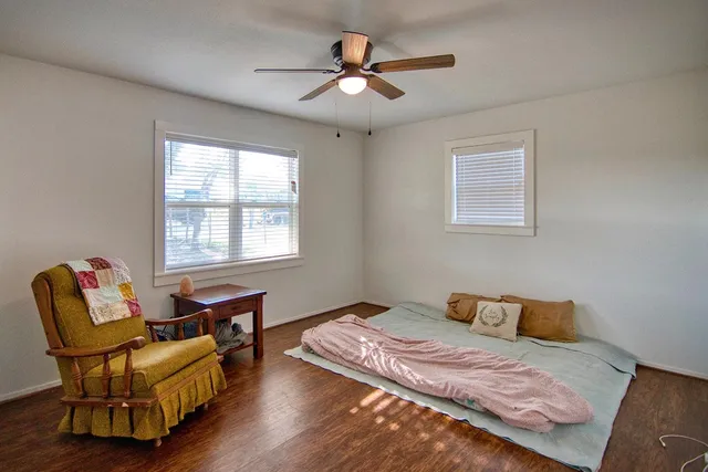a view of a livingroom with wooden floor and white walls