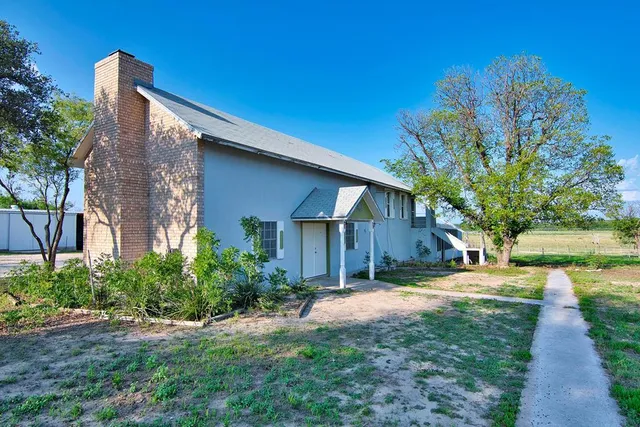 a view of a back yard with a wooden fence