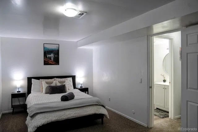 a bedroom with a bed and a night stand