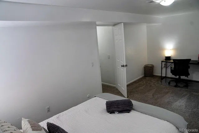 a bedroom with a bed and a tv on the table