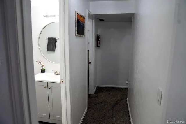 a view of a bathroom from a hallway