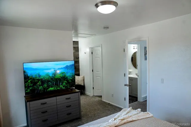 a view of a livingroom with wooden floor and cabinet