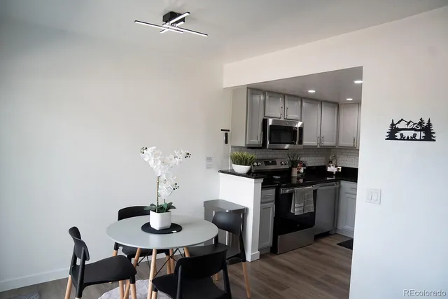 a kitchen with a table and chairs in it