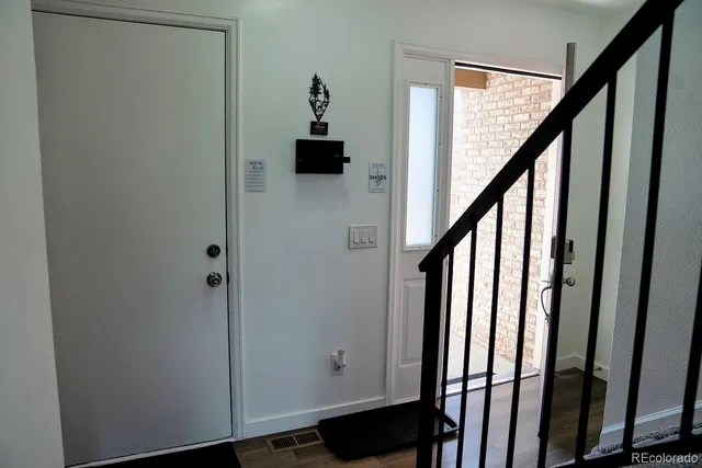 a view of an entryway with wooden floor
