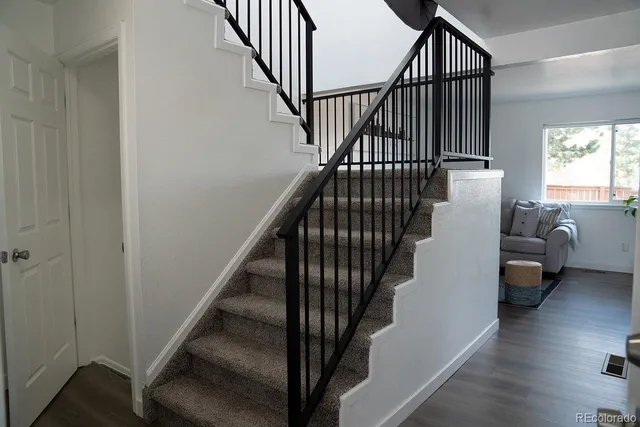 a view of entryway and hall with wooden floor
