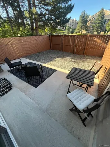 a view of a backyard with sitting area
