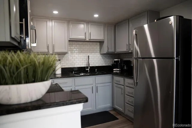a kitchen with a refrigerator and a sink