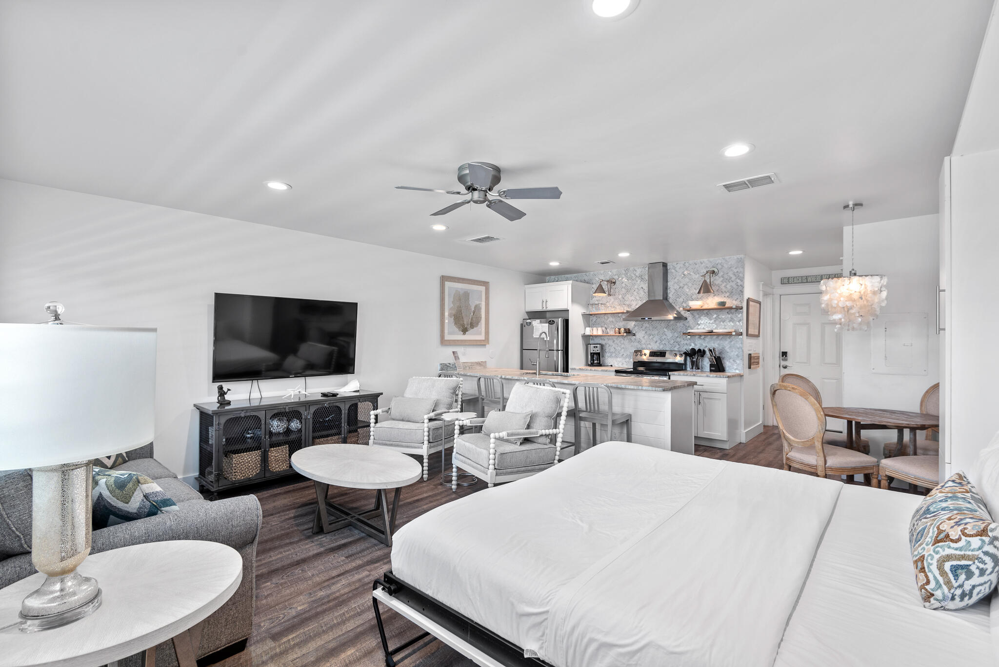 3605 East County Highway 30A, Unit 241 Santa Rosa Beach, FL 32459 - Photo 2 of 23 a living room with furniture a flat screen tv and kitchen view