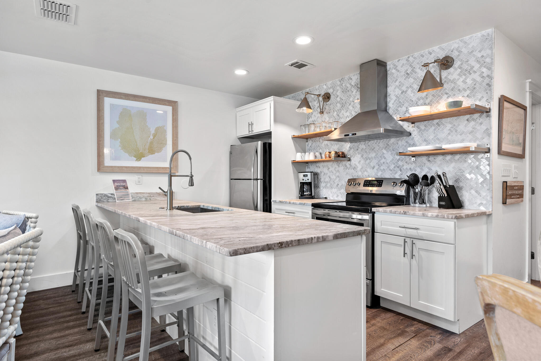 3605 East County Highway 30A, Unit 241 Santa Rosa Beach, FL 32459 - Photo 5 of 23 a kitchen with stainless steel appliances a sink a stove a refrigerator cabinets and dining table