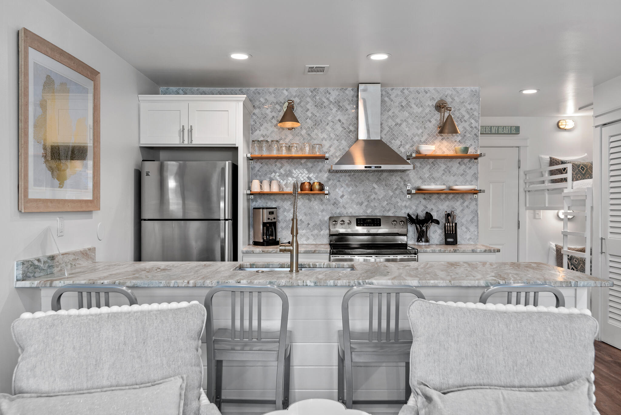 3605 East County Highway 30A, Unit 241 Santa Rosa Beach, FL 32459 - Photo 7 of 23 a kitchen with stainless steel appliances granite countertop a refrigerator a stove a sink and a dining table