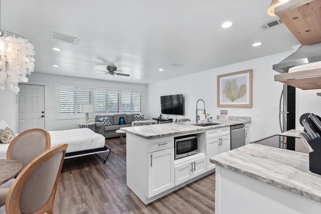 a kitchen that has a sink and a stove in it