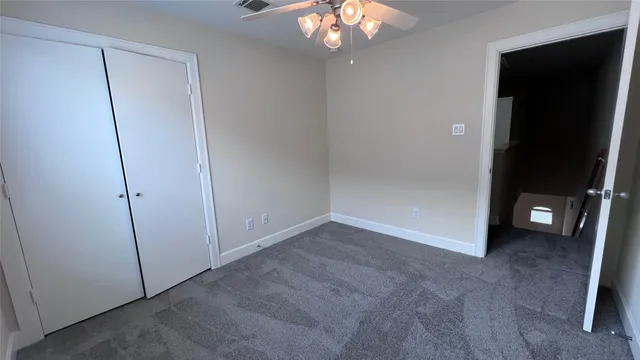 a view of an empty room with a mirror