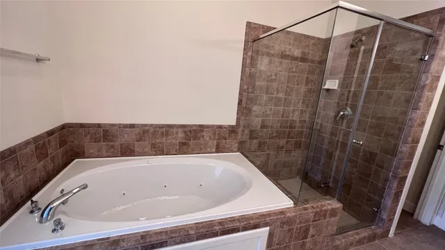a bathroom with a double vanity sink a large mirror and a shower
