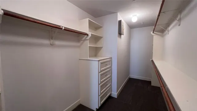 a spacious bathroom with a double vanity sink a mirror and a shower