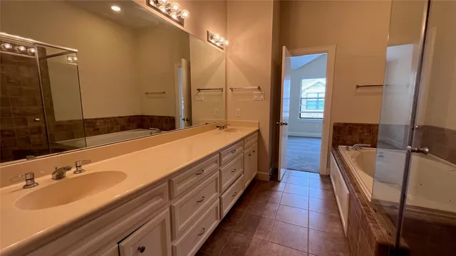 a view of a hallway with wooden floor and a ceiling fan