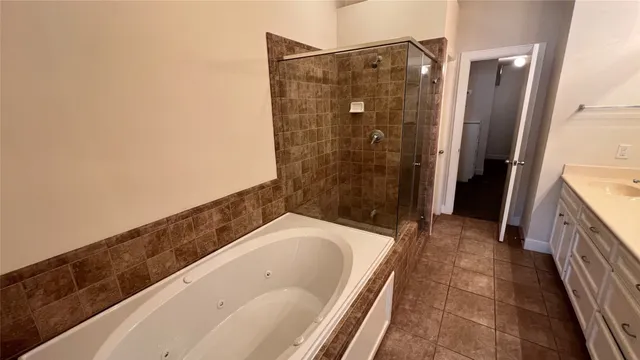 a bathroom with a bathtub and shower