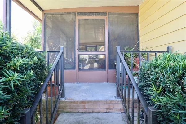 a view of a house with a patio and a yard