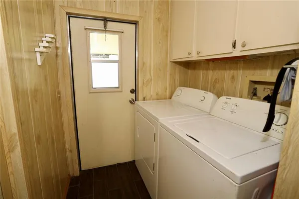 a bedroom with furniture and large windows