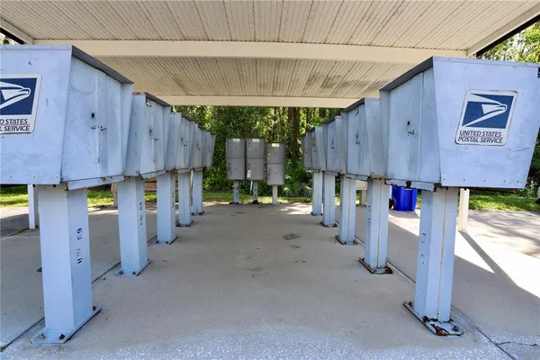 a kitchen with stainless steel appliances kitchen island granite countertop a table chairs in it and wooden floors