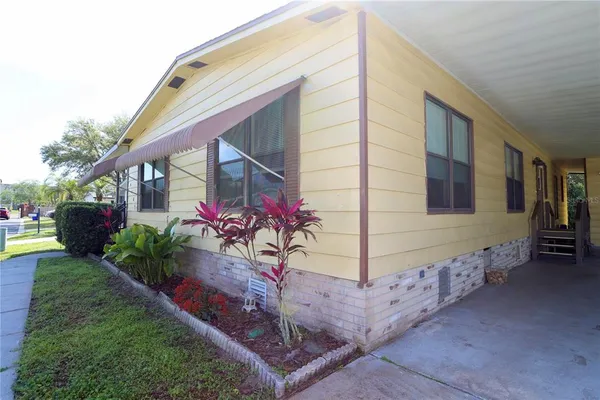 a view of a patio with table and chairs with wooden floor and fence