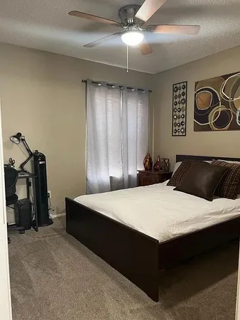a bed room with a bed and a chair