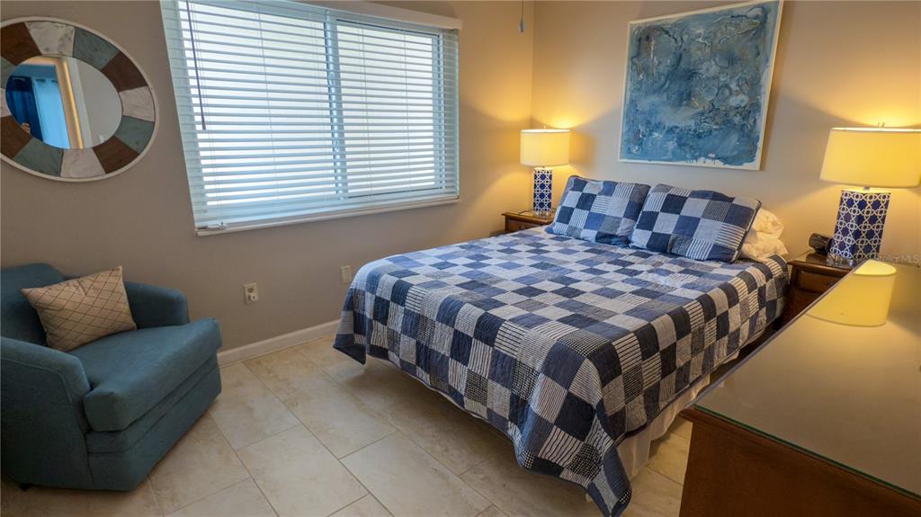 1900 Benjamin Franklin Drive, Unit 201BER Sarasota, FL 34236 - Photo 13 of 21 a bedroom with a bed couch and window