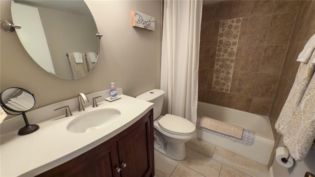 1900 Benjamin Franklin Drive, Unit 201BER Sarasota, FL 34236 - Photo 15 of 21 a bathroom with a sink toilet and shower