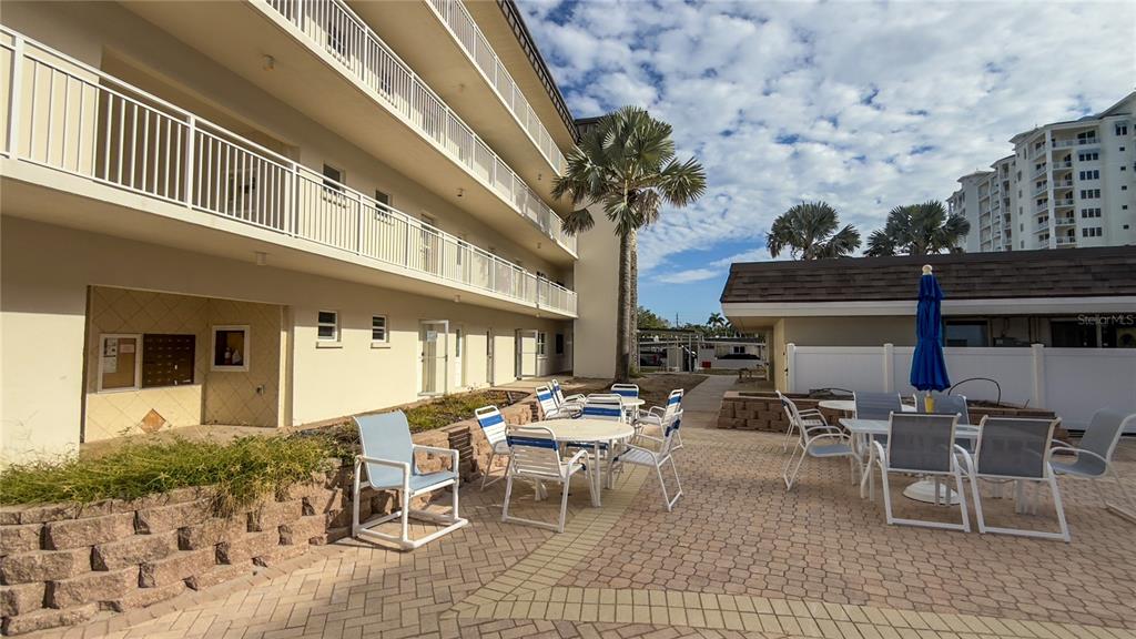 1900 Benjamin Franklin Drive, Unit 201BER Sarasota, FL 34236 - Photo 16 of 21 a building outdoor space with patio furniture and potted plants