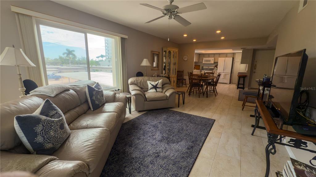 1900 Benjamin Franklin Drive, Unit 201BER Sarasota, FL 34236 - Photo 7 of 21 a living room with furniture and a flat screen tv
