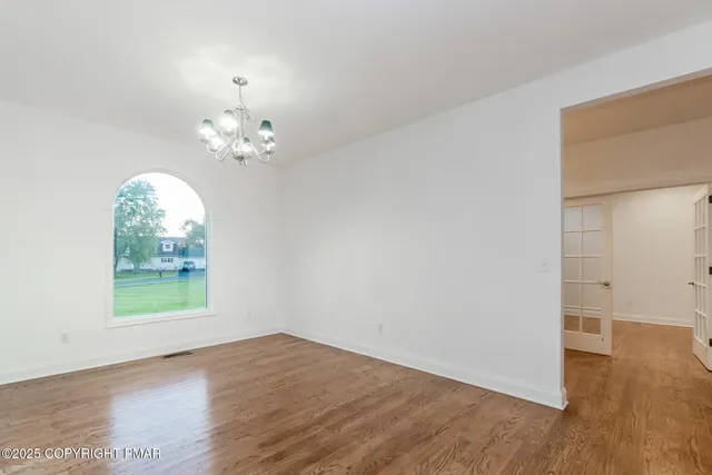 a kitchen with granite countertop a sink cabinets and wooden floor