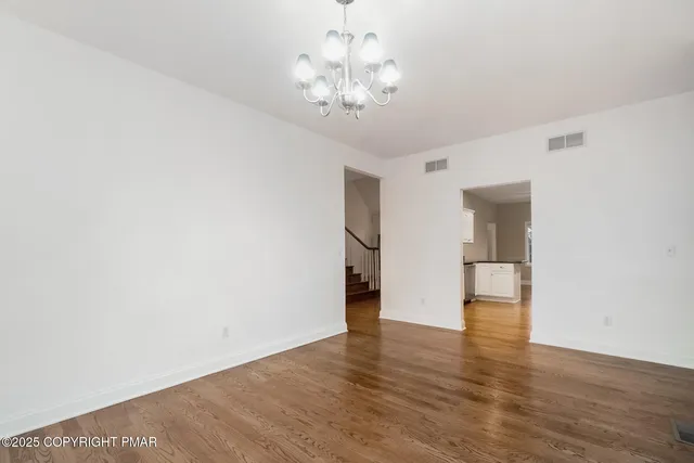 a kitchen with stainless steel appliances granite countertop a refrigerator and a stove