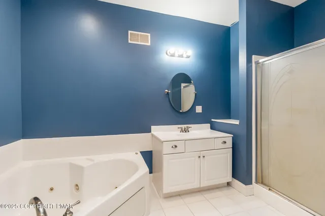 an empty room with a ceiling fan and carpet