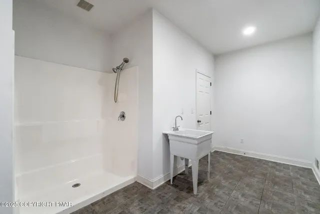a view of empty room with wooden floor