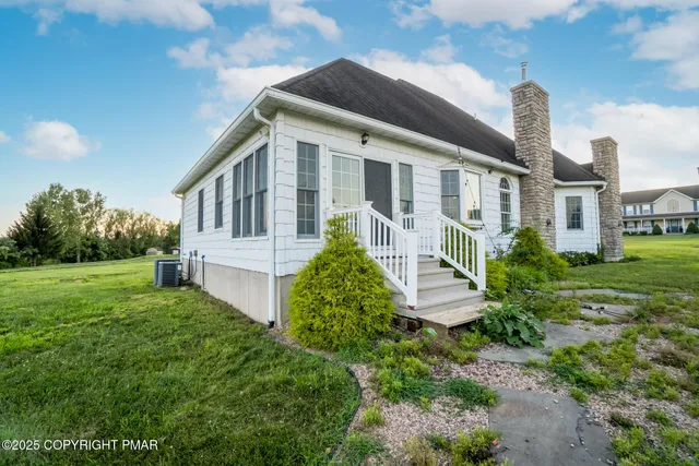 a front view of a house with a garden