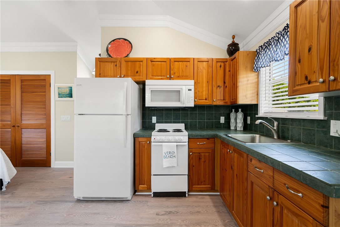 1675 34th Avenue, Unit A Vero Beach, FL 32960 - Photo 1 of 21 a kitchen with stainless steel appliances granite countertop a refrigerator a stove and a sink