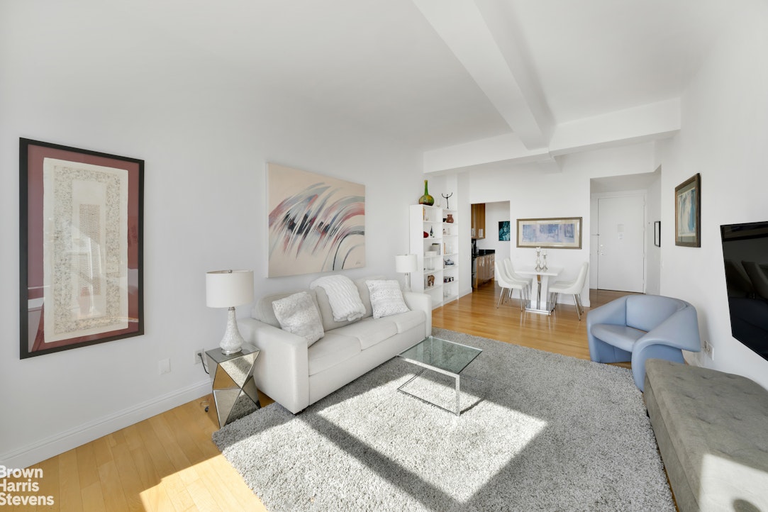 88 Greenwich Street, Unit 2704 Manhattan, NY 10006 - Photo 3 of 12 a living room with furniture and a flat screen tv