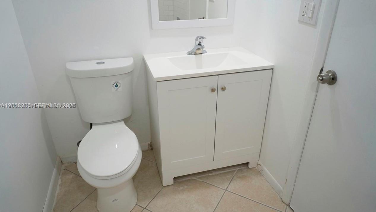 2771 Riverside Drive, Unit 405A Coral Springs, FL 33065 - Photo 14 of 19 a bathroom with a toilet sink and mirror