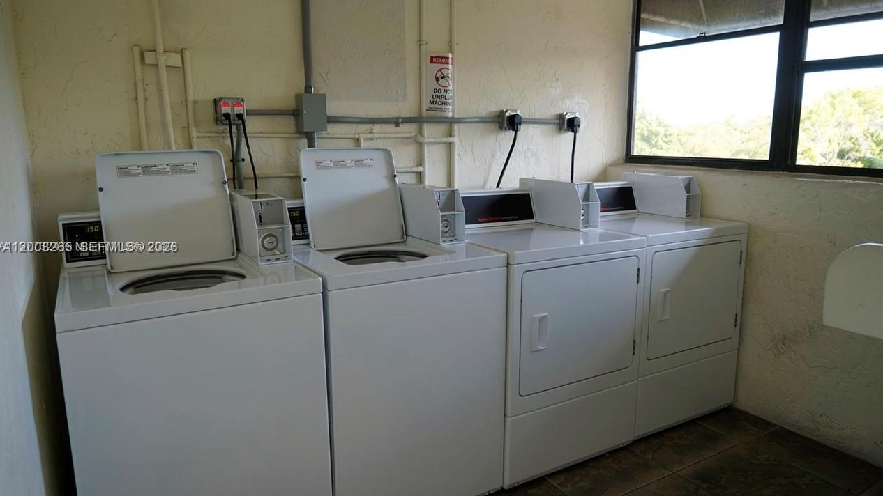 2771 Riverside Drive, Unit 405A Coral Springs, FL 33065 - Photo 16 of 19 a utility room with dryer and washer