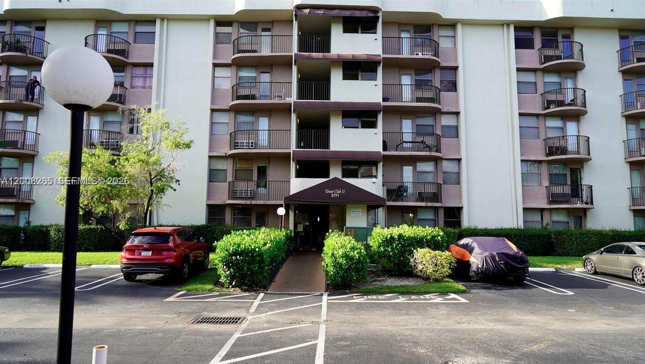 2771 Riverside Drive, Unit 405A Coral Springs, FL 33065 - Photo 17 of 19 a front view of a building with cars parked