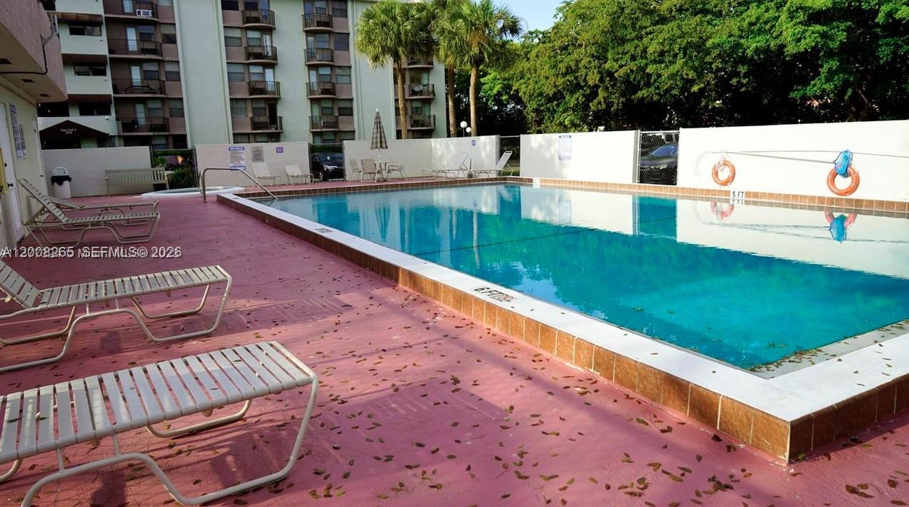 2771 Riverside Drive, Unit 405A Coral Springs, FL 33065 - Photo 18 of 19 a view of an outdoor space with a swimming pool